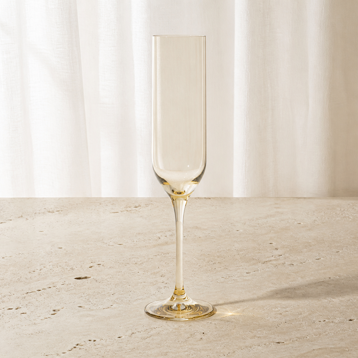 Marver champagne flute in Ochre, a muted honey gold on a slender drawn stem