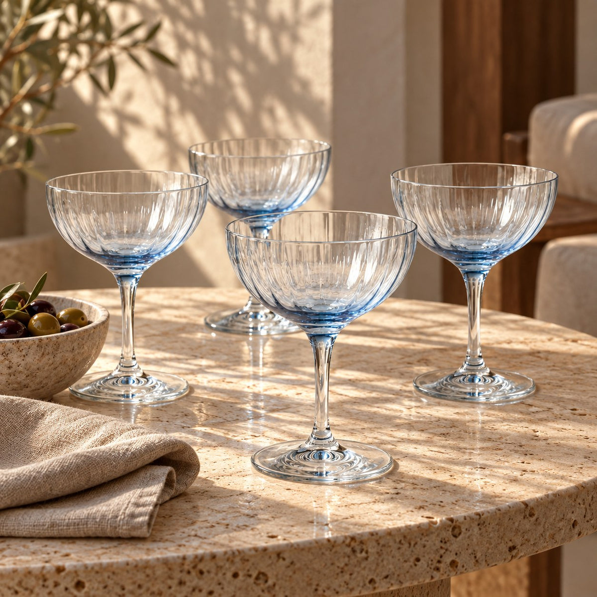 Lume Delft reeded coupes, four on a travertine table