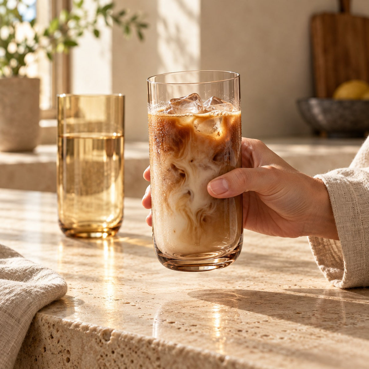 Marver Alabaster and Ochre highball glasses with iced coffee in a morning kitchen