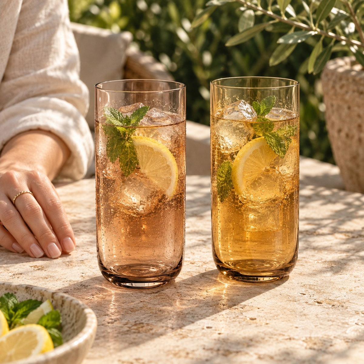 Marver Alabaster and Ochre highball glasses with iced tea on a summer terrace