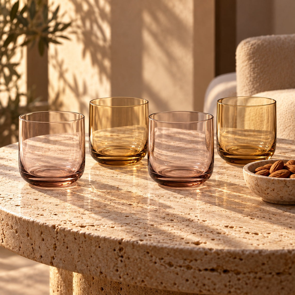 Marver Alabaster and Ochre old fashioned glasses, set of four on a travertine table