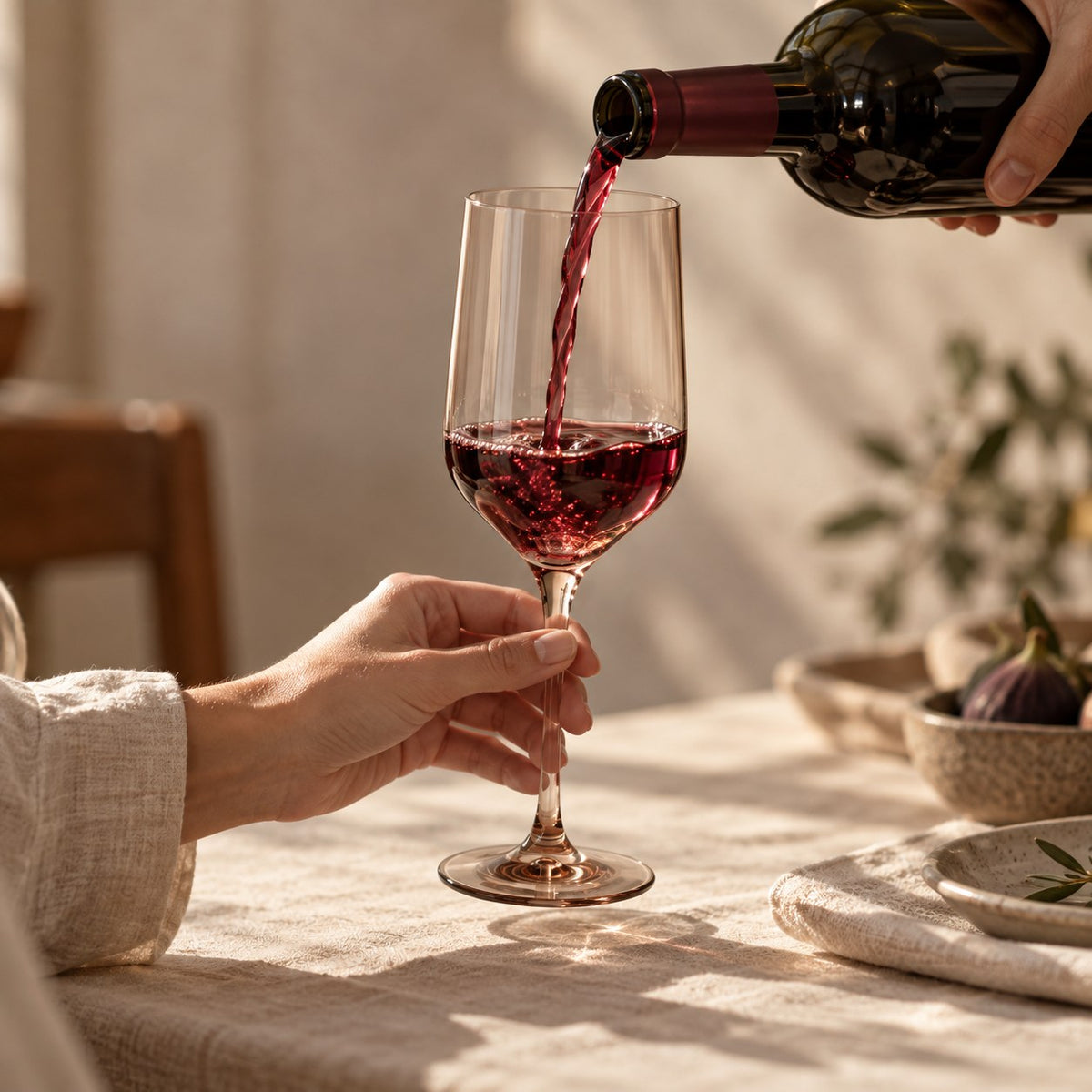 Marver Alabaster and Ochre wine glasses with red wine being poured
