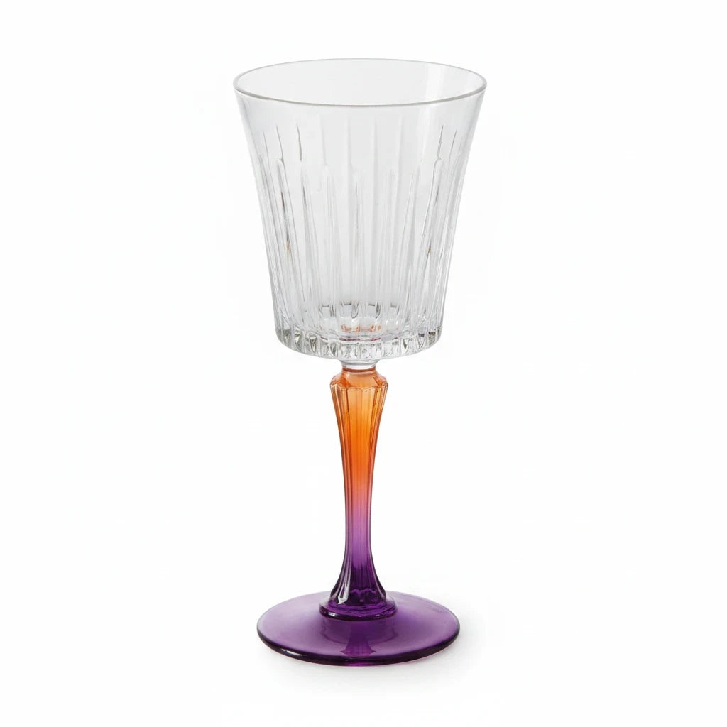 Tint & Form Vesper handblown crystal wine glass with a clear vertical-cut bowl and a gold-to-cobalt gradient stem.